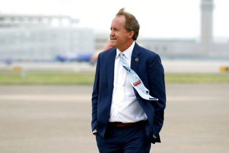 In this June 28, 2020, file photo, Texas Attorney General Ken Paxton waits on the flight line for the arrival of Vice President Mike Pence at Love Field in Dallas. Paxton had an extramarital affair with a woman whom he later recommended for a job with the wealthy donor now at the center of criminal allegations against him, according to two people who said Paxton told them about the relationship.