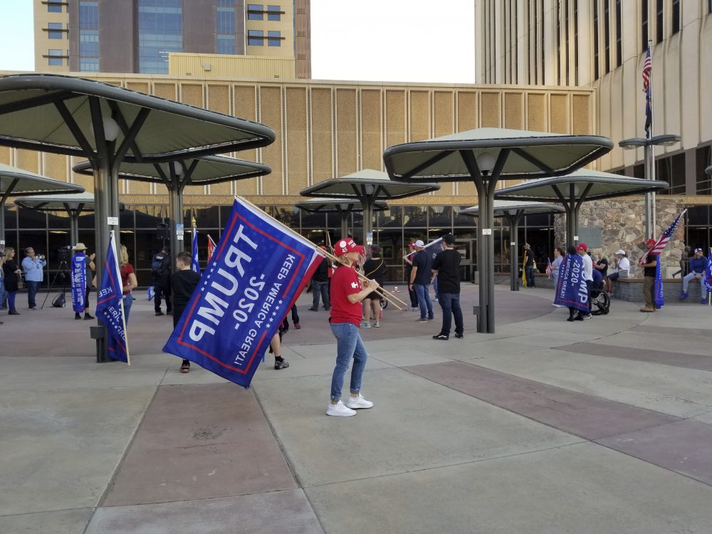 Supporters of Donald Trump gather on Friday, Nov. 20, 2020 in Phoenix, outside where the Maricopa County Board of Supervisors are meeting about certifying election votes. The elected leaders of Arizona's most populous county were expected to certify election results Friday that showed Democrat Joe Biden won the most votes. 