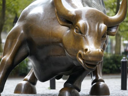 The Charging Bull statue is shown in New York's financial district. The Dow surpassed 30,000 points for the first time after President Trump allowed the transition process to begin.