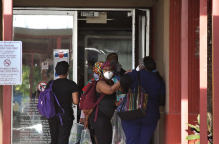 Healthcare workers enter the McAllen Medical Center during a shift change in July.