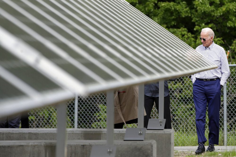 Former vice president and Democratic presidential candidate Joe Biden looks at an array of solar panels during a tour at the Plymouth Area Renewable Energy Initiative, Tuesday, June 4, 2019, in Plymouth, N.H.