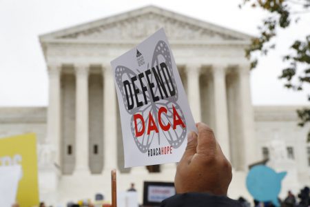 In this Nov. 12, 2019, file photo people rally outside the Supreme Court over President Trump's decision to end the Deferred Action for Childhood Arrivals program (DACA), at the Supreme Court in Washington. A Tuesday, Dec. 22, 2020 federal court hearing in Houston over a U.S. program shielding immigrants brought to the country illegally as children highlights the peril the program still faces even under an incoming Democratic president who has pledged to protect it. (AP Photo/Jacquelyn Martin, File)
