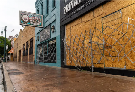 Workers boarded up bars on Sixth Street in Austin after Gov. Greg Abbott closed bars for a second time in June. After a financially devastating year, out-of-work Texans were dealt another blow this week when a congressional coronavirus relief package's fate became uncertain after President Donald Trump threatened to veto it.