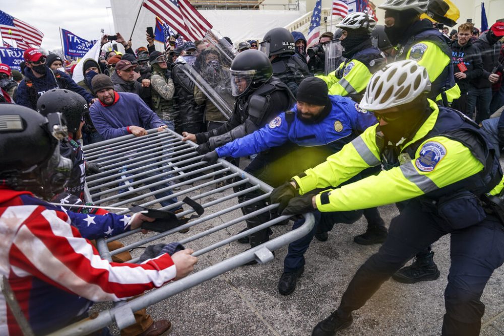 Trump supporters try to break through a police barrier, Wednesday, Jan. 6, 2021, at the Capitol in Washington. 