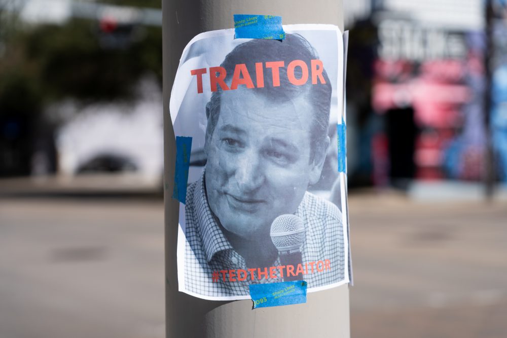 Anti-Trump protestors on Jan. 7, 2021 in downtown Houston put up flyers calling U.S. Sen. Ted Cruz a traitor, after the Texas Republican voted to reject the election results. 