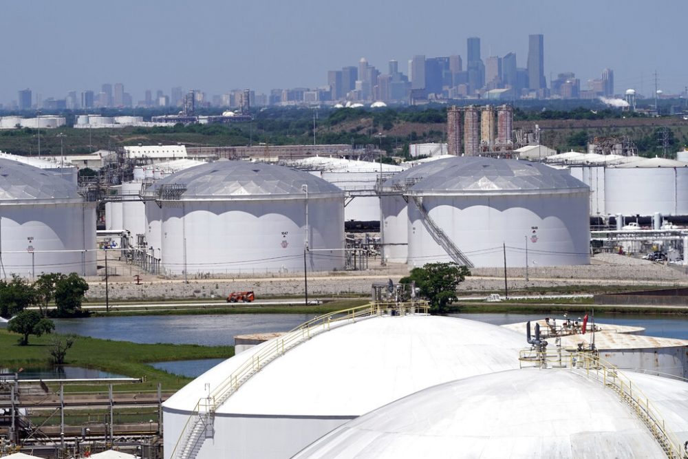 In this Thursday, April 30, 2020, photo storage tanks along the Houston Ship Channel are seen with downtown Houston in the background.
