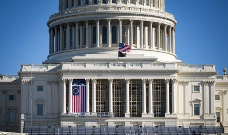 The American flag flies at half-staff on the west front of the U.S. Capitol on Saturday. On Monday, House Democrats introduced an impeachment resolution against President Trump over his role in last week's insurrection.