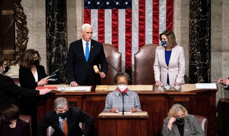 Vice President Pence, pictured alongside House Speaker Nancy Pelosi, presides over a joint session of Congress to certify the 2020 Electoral College results after supporters of President Trump stormed the Capitol on Jan. 6. A new House resolution calls on Pence to assume the presidency.