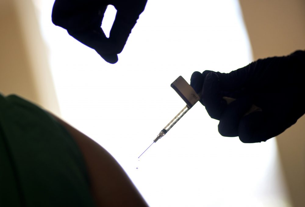 In this Dec. 15, 2020, file photo, a droplet falls from a syringe after a health care worker was injected with the Pfizer-BioNTech COVID-19 vaccine at Women &amp; Infants Hospital in Providence, R.I. Uncertainty over the pace of federal COVID-19 vaccine allotments triggered anger and confusion Friday, Jan. 15, 2021, in some states where officials worried that expected shipments would not be forthcoming. 