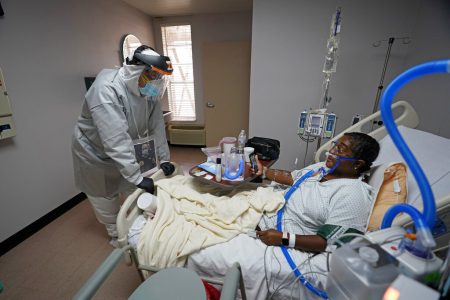 Dr. Joseph Varon, left, talks with patient LaTanya Robinson inside the Coronavirus Unit at United Memorial Medical Center, Monday, July 6, 2020, in Houston.