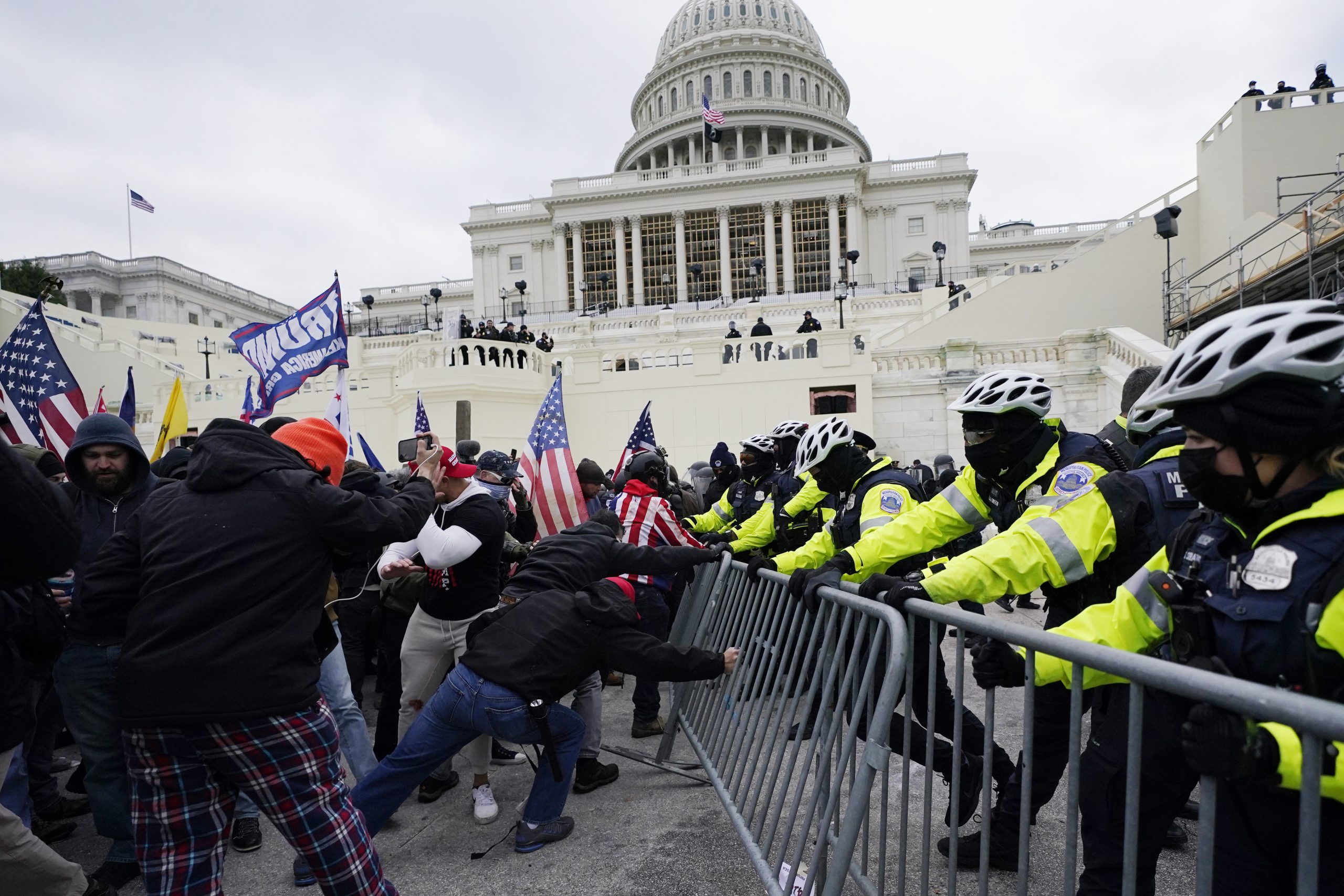 Trump supporters try to break through a police barrier, Wednesday, Jan. 6, 2021, at the Capitol in Washington. As Congress prepares to affirm President-elect Joe Biden's victory, thousands of people have gathered to show their support for President Donald Trump and his claims of election fraud.