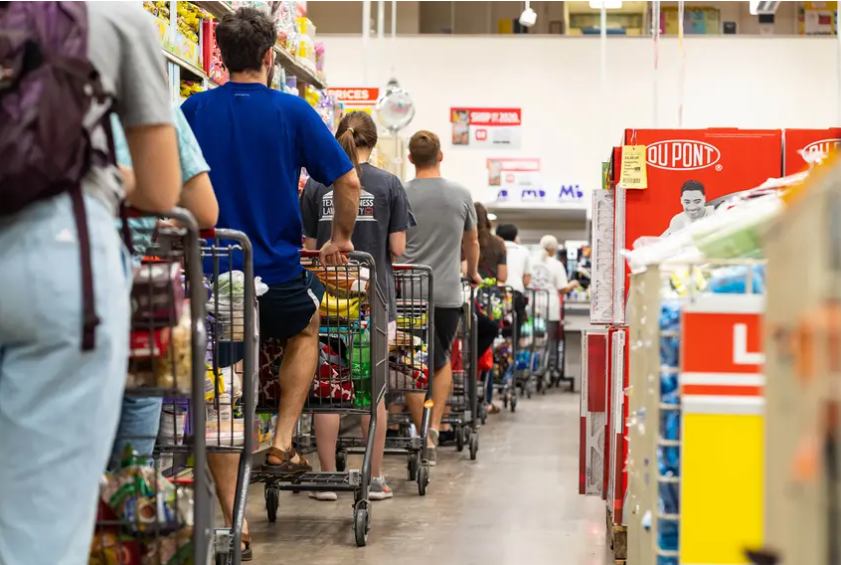 Grocery shoppers formed a long line at the H-E-B grocery store at Hancock Center in Austin last year. Grocery store employees were called essential when the pandemic began, but haven't been given priority access to the coronavirus vaccine.