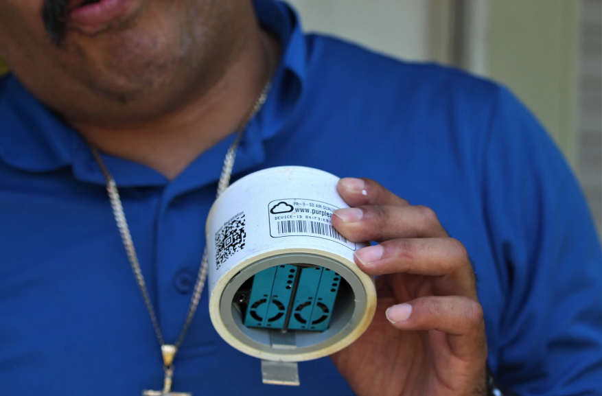 Juan Flores holds one of the air monitors he uses for his work with Air Alliance Houston.