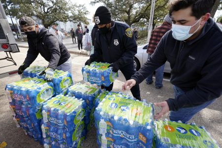 Donated water is distributed to residents, Thursday, Feb. 18, 2021, in Houston. Houston and several surrounding cities are under a boil water notice as many residents are still without running water in their homes.