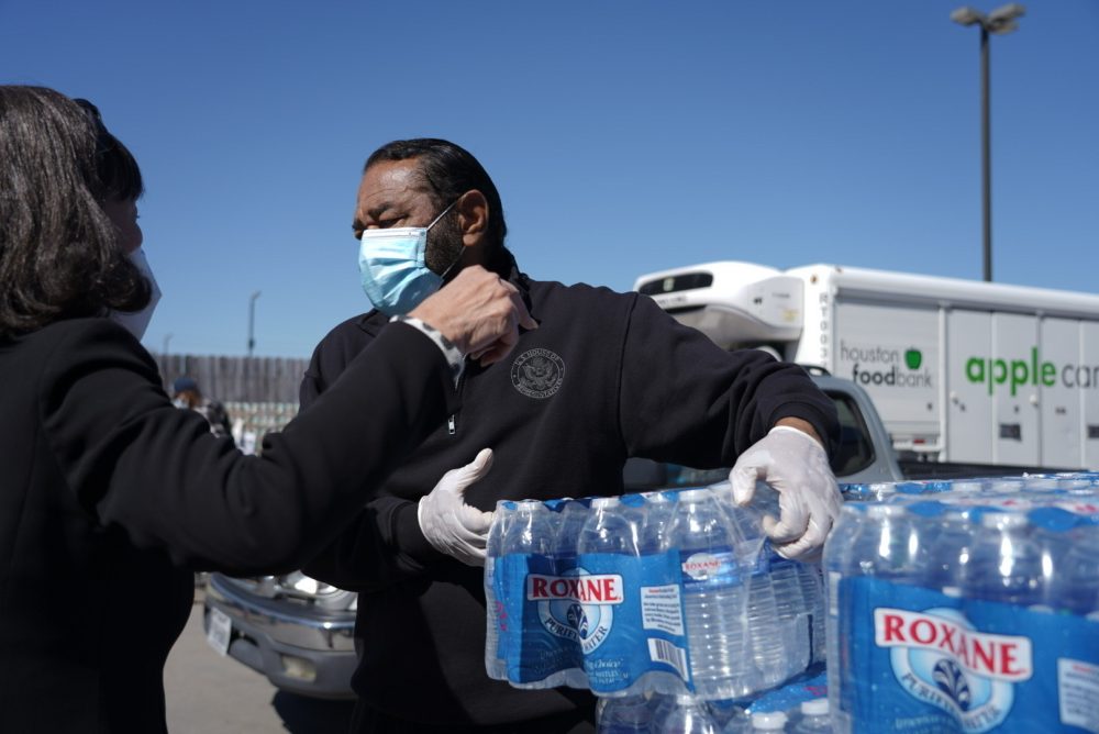 U.S. Rep. Al Green, D-Houston, loads cases of water into a car at the Bethel’s Heavenly Hands food pantry in Houston on Feb. 22, 2021.