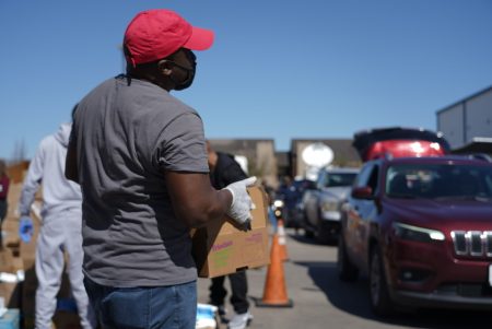 A volunteer packs food and water at a Houston distribution site on Feb. 22, 2021.