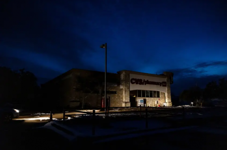 A CVS Pharmacy in South Austin is lit only by the lights of a parked car. Various parts throughout the state lost power as a result of the winter storm.