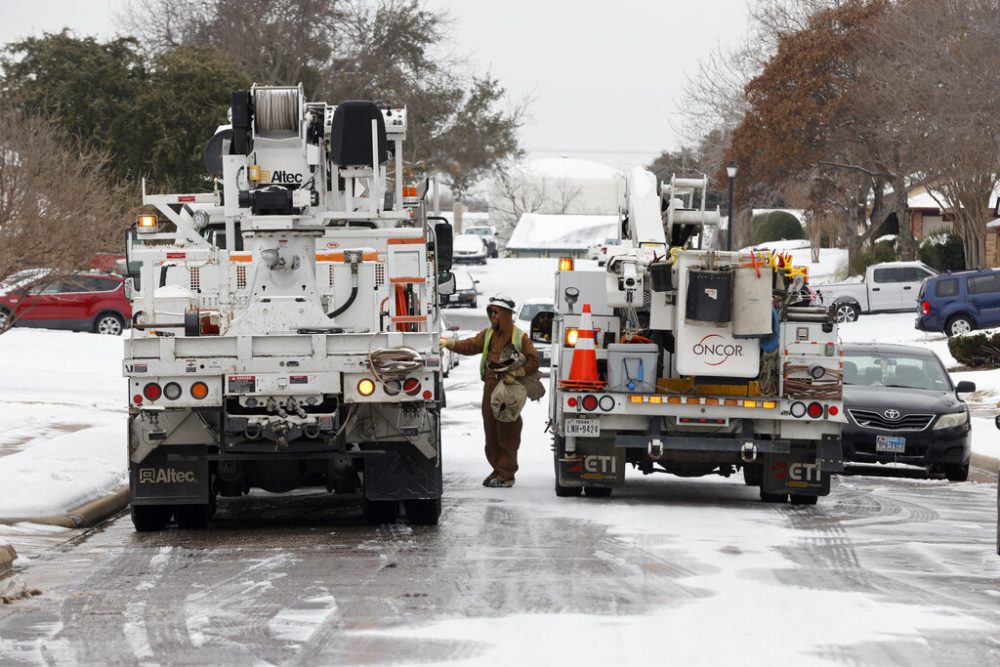 Crews work to restore power to homes in Euless, Texas, Thursday, Feb. 18, 2021.