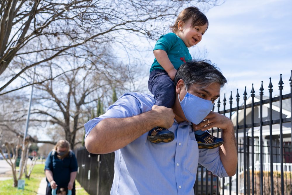 Sudiptya Banerjee and his wife Sara Gencui outside of their house with their two sons. Taken on March 4, 2021. 