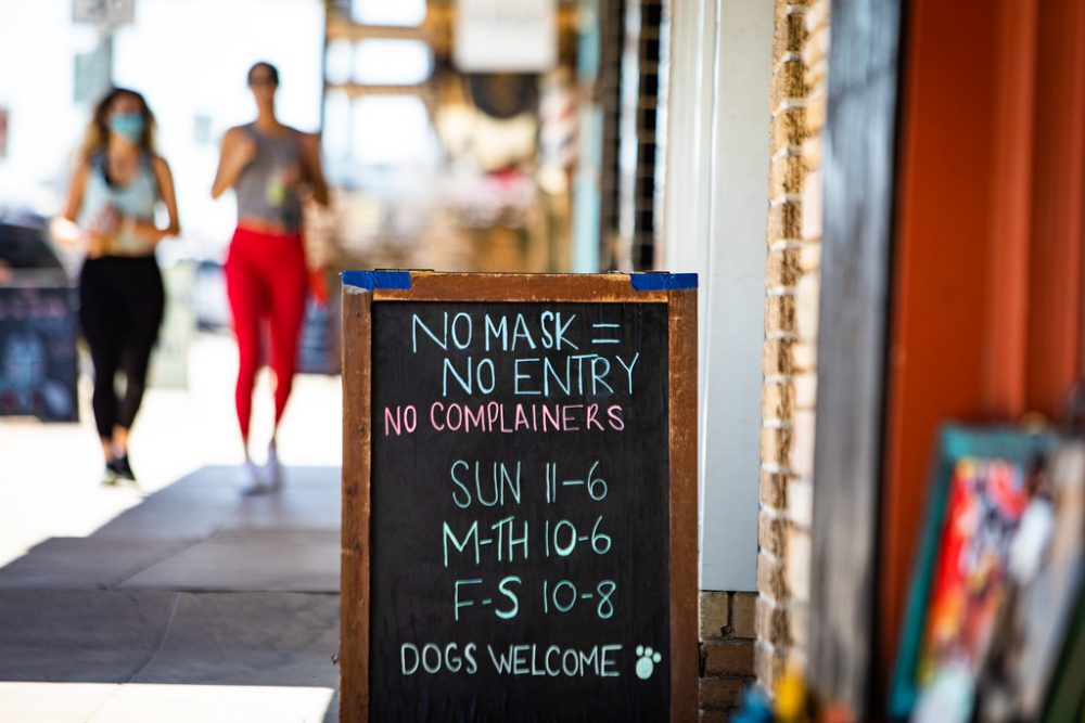 A sign outside of an Austin business tells customers to wear a mask when entering. Gov. Greg Abbott lifted a statewide mask mandate beginning Wednesday, March 10, 2021, but many businesses have decided to enforce the rule regardless.