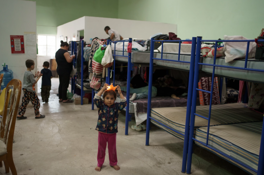 Linda, 3, plays inside “Albergue Para Migrantes El Buen Samaritano” while others pack up their belongings in preparation to enter the United States, in Ciudad Juárez, Mexico on March 9, 2021. The shelter would say farewell to 13 people who had waited out their asylum cases under Migrant Protection Protocols the following morning.