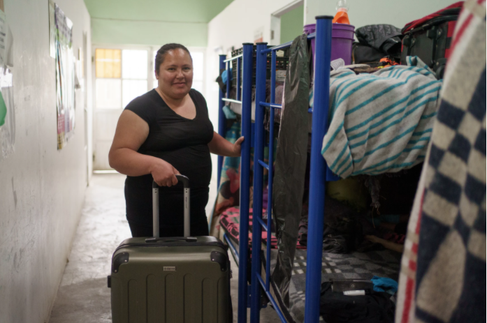 Guatemalan Ingrid Lizette Munoz Ramos, 32, is pictured with her suitcase on the night before she was to leave "Albergue Para Migrantes El Buen Samaritano," in Ciudad Juárez, Mexico on March 9, 2021. Migrants in the Migrant Protection Protocols are beginning to enter the United States, but many are left behind, and more are arriving at the border every day.