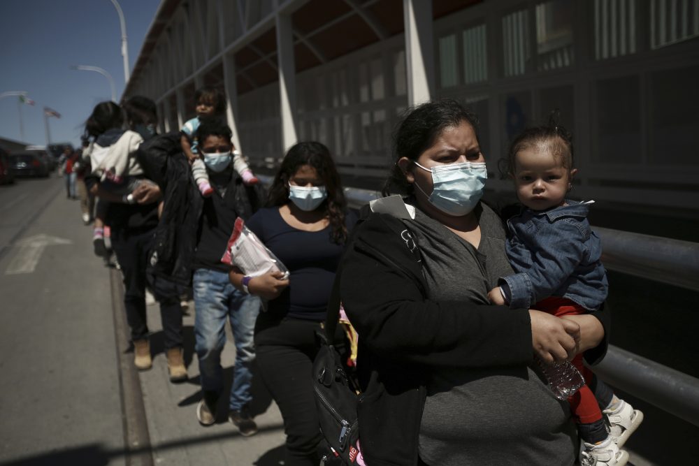 Migrants deported from the U.S. walk into Ciudad Juarez, Mexico, Tuesday, March 23, 2021. Mexico announced that U.S. advisers on border and immigration issues will meet with Mexican officials on Tuesday to discuss migration and development in Central America, as a surge of migrants has hit the U.S. southern border. 