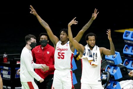 Houston's Brison Gresham (55) and Justin Gorham, right, celebrate from the bench after a score against Rutgers late in the second half of a college basketball game in the second round of the NCAA tournament at Lucas Oil Stadium in Indianapolis Sunday, March 21, 2021. Houston won 63-60.