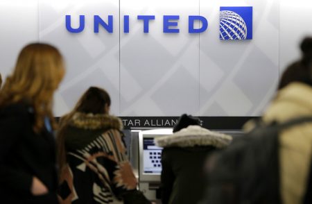 In this March 15, 2017, photo, people stand in line at a United Airlines counter at LaGuardia Airport in New York. A dog died on a United Airlines plane after a flight attendant ordered its owner to put the animal in the plane's overhead bin. United said Tuesday, March 13, 2018, that it took full responsibility for the incident on the Monday night flight from Houston to New York.