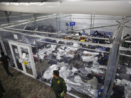 Young minors lie inside a pod at the Donna Department of Homeland Security holding facility, the main detention center for unaccompanied children in the Rio Grande Valley run by U.S. Customs and Border Protection (CBP), in Donna, Texas, Tuesday, March 30, 2021. The minors are housed by the hundreds in eight pods that are about 3,200 square feet in size. Many of the pods had more than 500 children in them. The Biden administration on Tuesday for the first time allowed journalists inside its main detention facility at the border for migrant children, revealing a severely overcrowded tent structure where more than 4,000 kids and families were crammed into pods and the youngest kept in a large play pen with mats on the floor for sleeping.