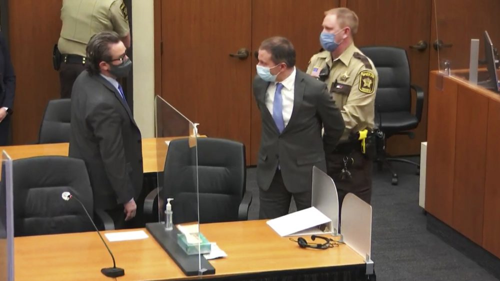 Former Minneapolis police officer Derek Chauvin is taken into custody as his attorney, Eric Nelson, looks on after the verdicts were read on Tuesday at Chauvin's trial for the 2020 death of George Floyd.