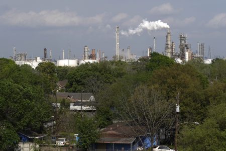 Homes are seen with The Valero Houston Refinery in the background.