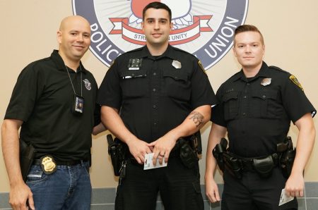 This photo from the Houston Police Officers Union website shows Lucas Vieira, center, and Thomas Serrano, right, receiving Patrol Officers of the Month honors in 2019.