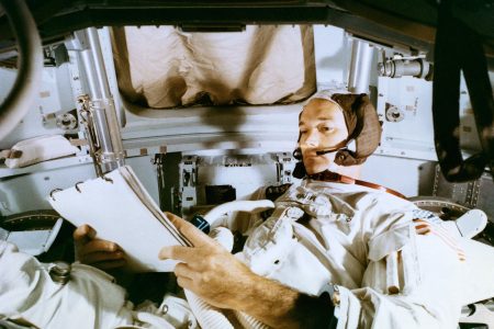 Collins studies the flight plan during simulation training at the Kennedy Space Center before the scheduled Apollo 11 mission.