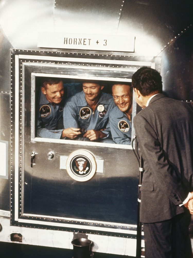 In 1969, President Richard Nixon greets the Apollo 11 astronauts in quarantine after their mission to the moon. The Apollo 11 crew members (from left) are Neil Armstrong, Collins and Buzz Aldrin.