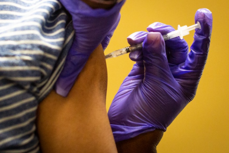 A person in Austin gets vaccinated for COVID-19.
