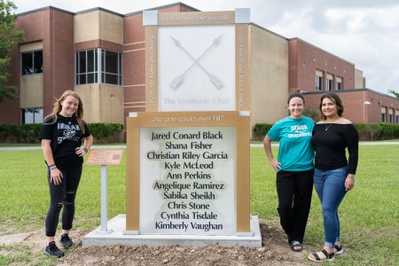 Chailyn Gillespie (left), Morgan Wilson (center), and Reagan Gaona (right) with the Unfillable Chair, a memorial built to represent the absence of the ten students and teachers who lost their lives during the shooting. Taken on May 17, 2021.