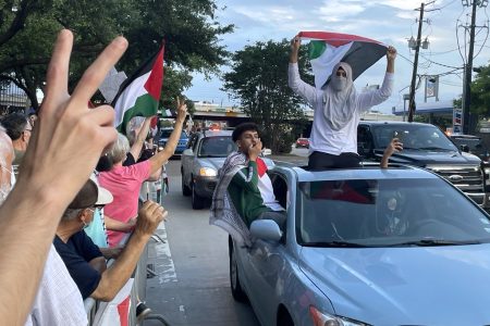 Supporters drive passed a crowd of pro-Palestinian protestors on May 18, 2021.