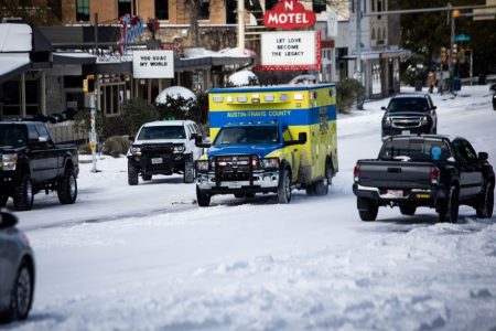 An Austin-Travis County EMS ambulance moves down South Congress Avenue on Feb. 15 during the Texas freeze.