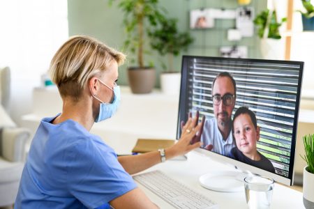 Sad woman doctor having video call with husband and son, social distancing concept.