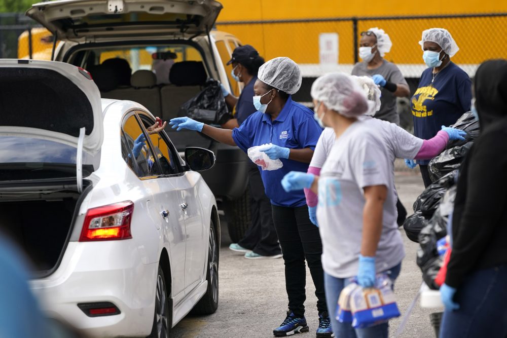 Houston Independent School District Nutrition Services workers distribute food Monday, April 6, 2020, in Houston. HISD relaunched their food distribution efforts throughout the district Monday, with a streamlined process that will implement increased safety measures. 