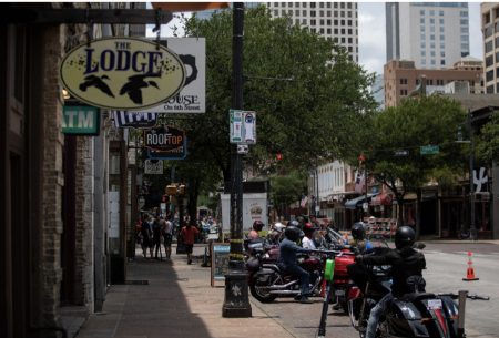 Bikers attending the Republic of Texas Motorcycle Rally are parked on East Sixth Street on Saturday, hours after a mass shooting.