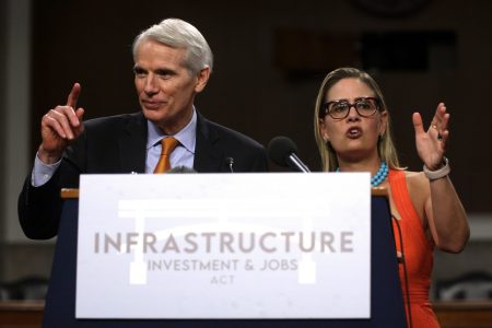 Sens. Rob Portman, R-Ohio, and Kyrsten Sinema, D-Ariz., take questions at a July 28 news conference after a procedural vote for the bipartisan infrastructure framework. The two led negotiations that resulted in the bill.