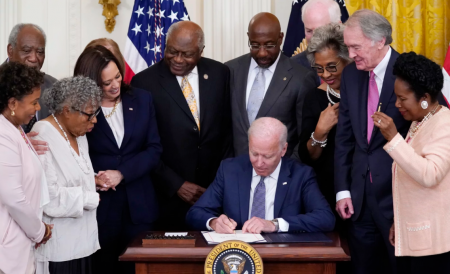 President Joe Biden signs the Juneteenth National Independence Day Act in the East Room of the White House on Thursday.