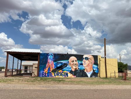 A mural in Van Horn features billionaire Jeff Bezos with a rocket blasting off behind him.