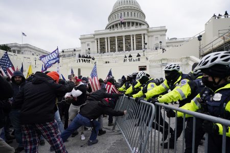 In this Jan. 6, 2021 file photo, violent rioters try to break through a police barrier at the Capitol in Washington.  U.S. Capitol Police Sgt. Aquilino Gonell and others would later testify on during the first hearing of the select committee investigating the insurrection, that he and other officers were "punched, pushed, kicked, shoved, sprayed with chemical irritants and even blinded with eye-damaging lasers."
