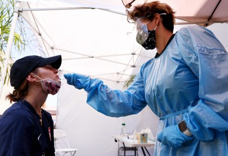 A medical assistant administers a coronavirus test last week in Los Angeles. COVID-19 cases are on the rise as the highly transmissible delta variant has become the dominant coronavirus strain in the United States.