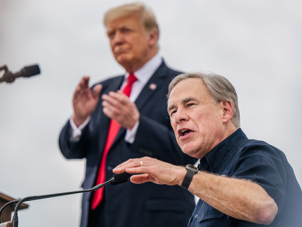 Texas Gov. Greg Abbott speaks alongside former President Donald Trump during a tour of an unfinished section of the border wall on June 30 in Pharr, Texas. Abbott says he'll continue Trump's border barrier, a pledge that is expected to help the governor in his reelection campaign.