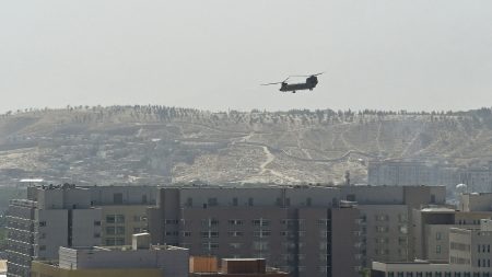 A U.S. military helicopter is pictured flying above the U.S. Embassy in Kabul on Sunday. The Taliban swept into Kabul, facing little resistance.