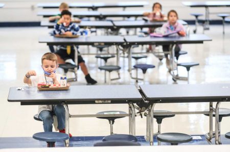 Students were spaced at least six feet apart in the cafeteria for lunch at Medora Elementary Wednesday morning. It was the first day back to school since the Covid-19 pandemic shut down in-person classes March 2020.